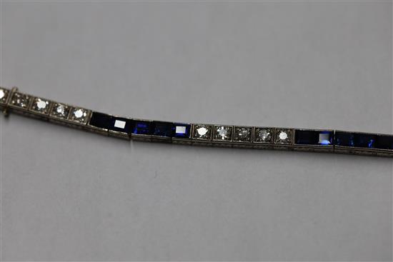 A 1920s 18ct white gold, sapphire and diamond set line bracelet, in original fitted Charles Packer & Co Ltd box.